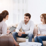 Couples therapy session with professional relationship counselor helping married couple improve communication and strengthen relationship